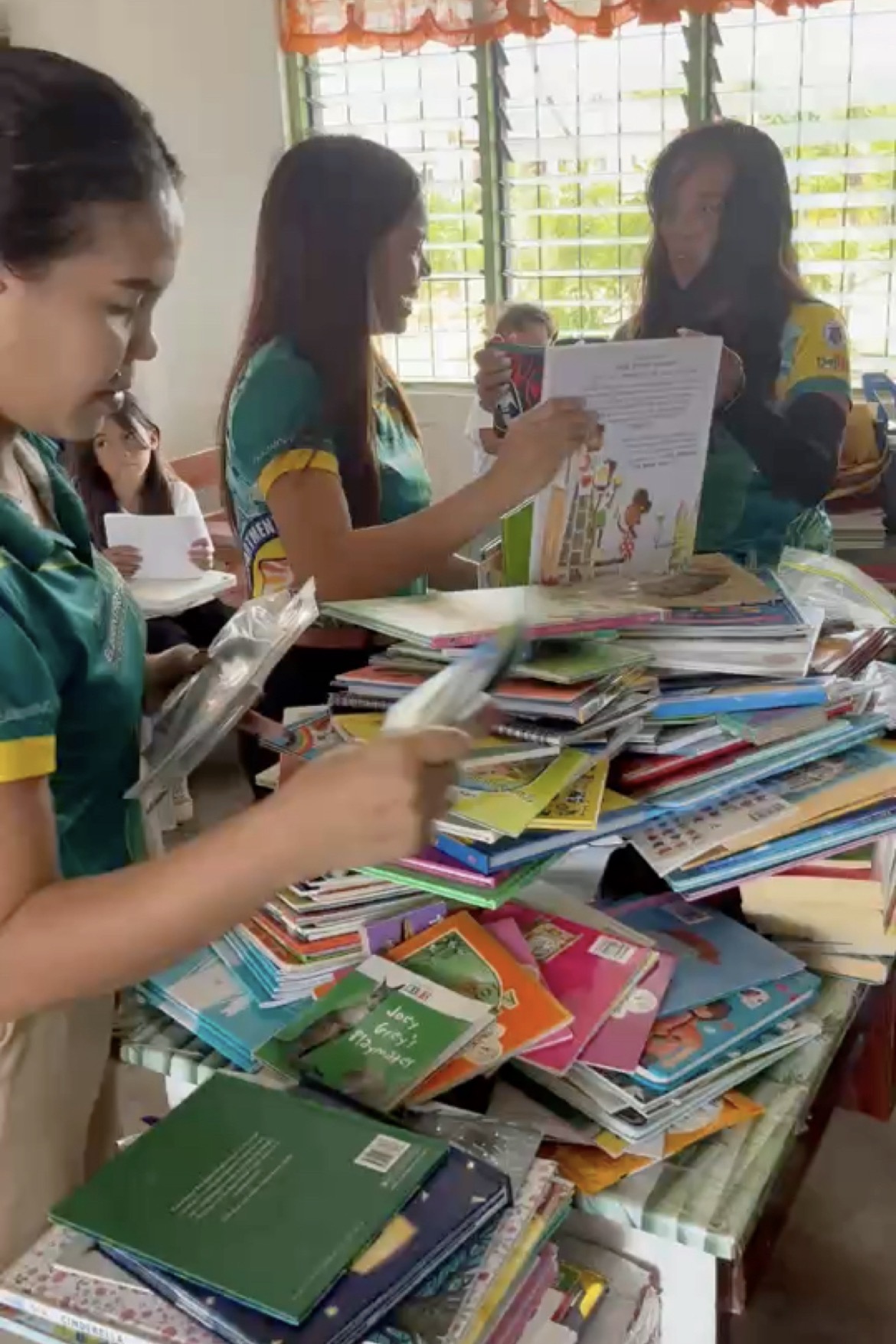 Teachers sorting donated children's books